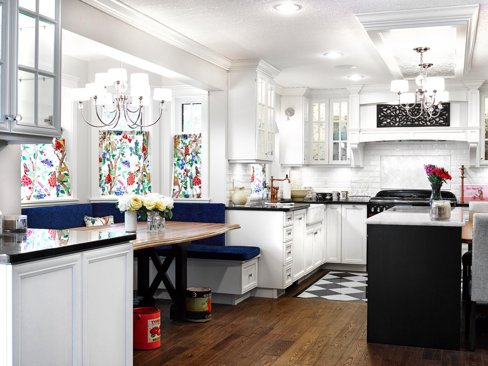 Medium sized eclectic u-shaped kitchen/diner with a belfast sink, shaker cabinets, white cabinets, white splashback, coloured appliances and an island.