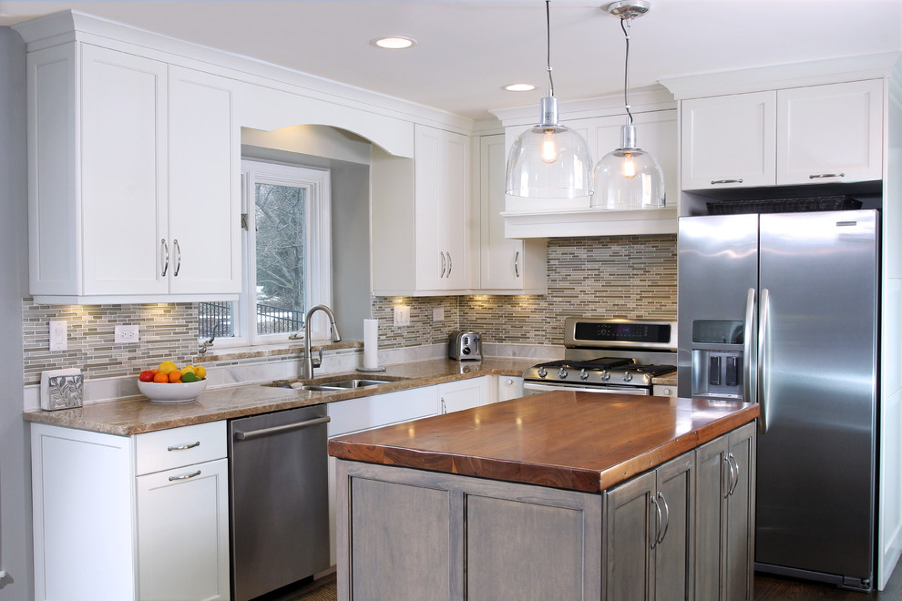Example of a mid-sized trendy l-shaped dark wood floor and brown floor eat-in kitchen design in Chicago with shaker cabinets, white cabinets, beige backsplash, stainless steel appliances, an island, an undermount sink, granite countertops and matchstick tile backsplash