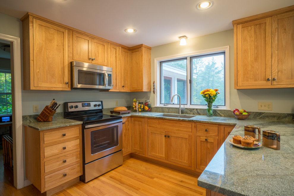 Eat-in kitchen - mid-sized traditional u-shaped light wood floor eat-in kitchen idea in Burlington with an undermount sink, recessed-panel cabinets, light wood cabinets, granite countertops, stainless steel appliances and a peninsula