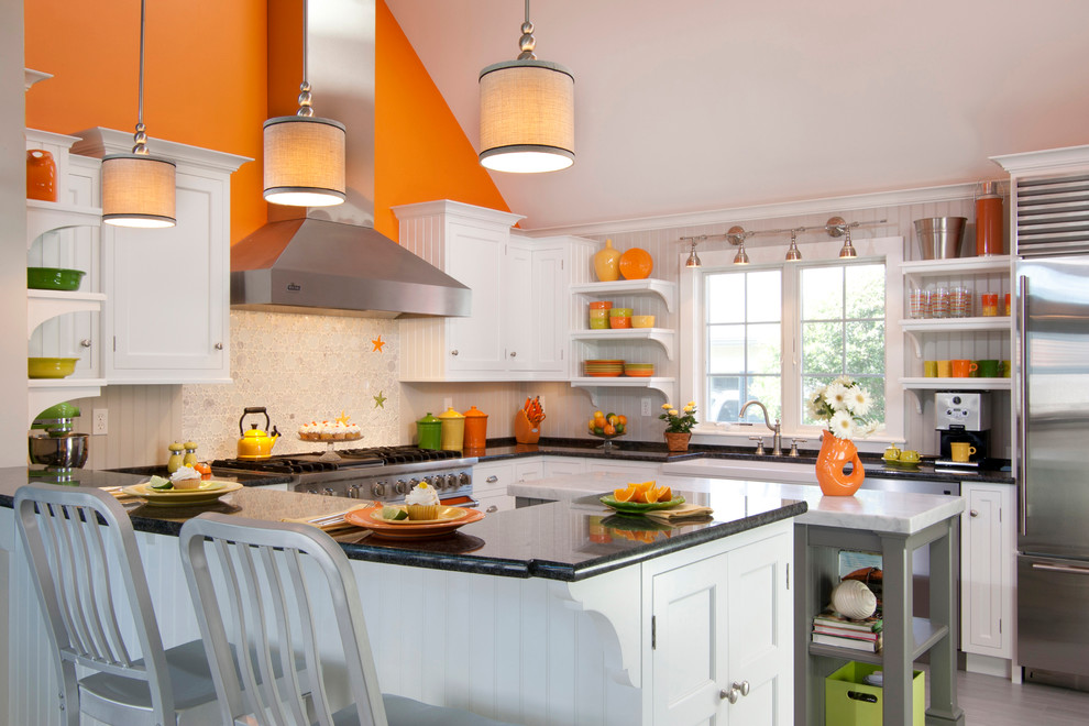 Example of a large country u-shaped ceramic tile and gray floor eat-in kitchen design in Other with a farmhouse sink, white cabinets, marble countertops, white backsplash, glass tile backsplash, colored appliances, an island and recessed-panel cabinets
