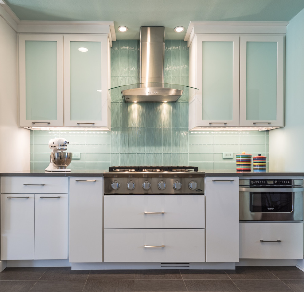 Large minimalist l-shaped eat-in kitchen photo in St Louis with an undermount sink, flat-panel cabinets, white cabinets, quartz countertops, blue backsplash, glass tile backsplash, white appliances and no island
