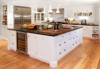 Cooking tools with wooden cutting boards, oil and shaker at white modern  kitchen interior. Stock Photo by Nadianb