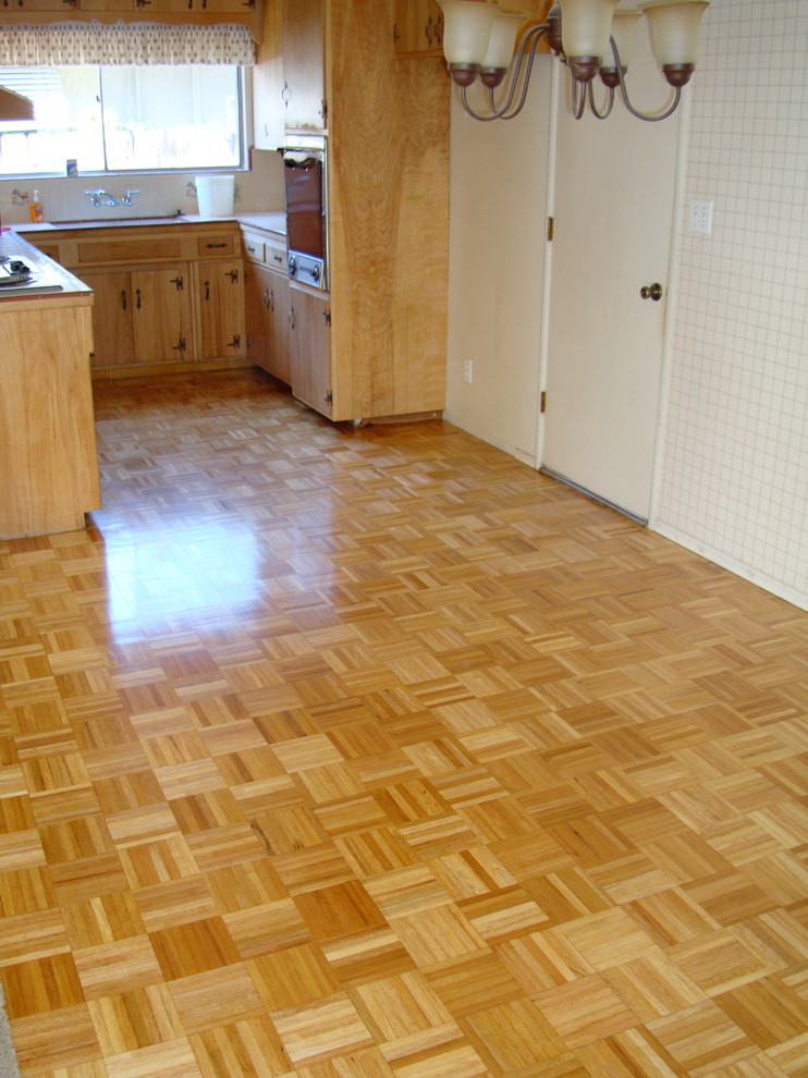 This is an example of a medium sized rural kitchen in Sacramento with light wood cabinets and light hardwood flooring.