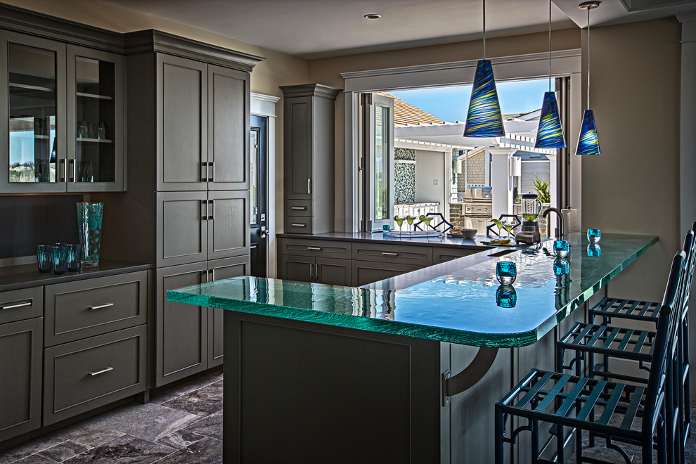 Ejemplo de cocina costera con armarios estilo shaker, puertas de armario verdes, encimera de vidrio, suelo de mármol y encimeras turquesas