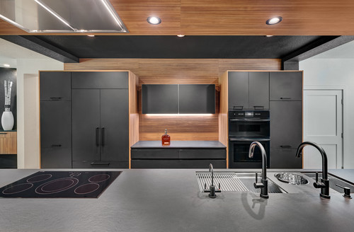 Modern Canadian kitchen with matte black cabinets and warm wood accents — showcasing one of the best kitchen cabinet colors Canada for a bold yet inviting look.