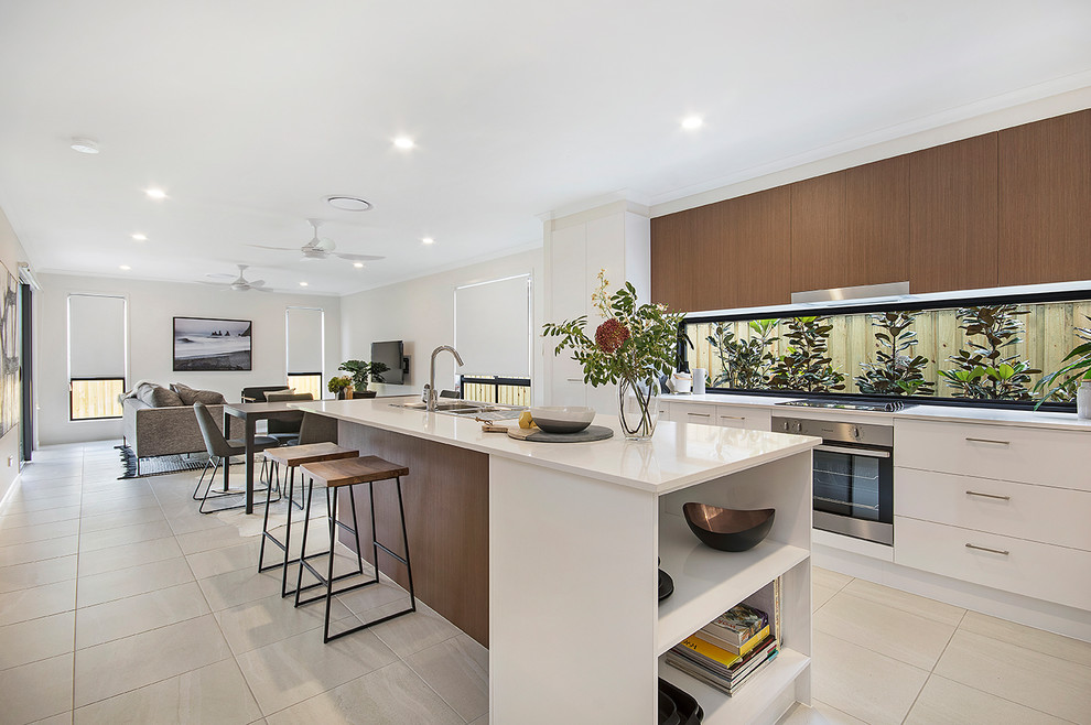 Example of a trendy galley cement tile floor and beige floor kitchen design in Sunshine Coast with dark wood cabinets, quartz countertops, window backsplash, stainless steel appliances and an island