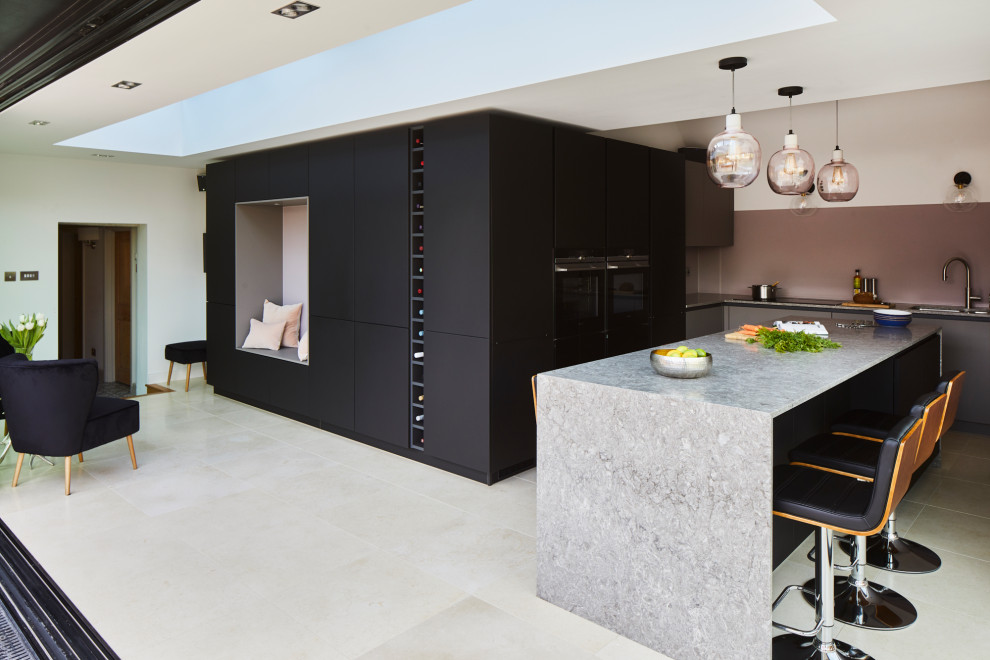 Design ideas for a medium sized contemporary l-shaped kitchen in Kent with flat-panel cabinets, black cabinets, quartz worktops, pink splashback, an island and grey worktops.