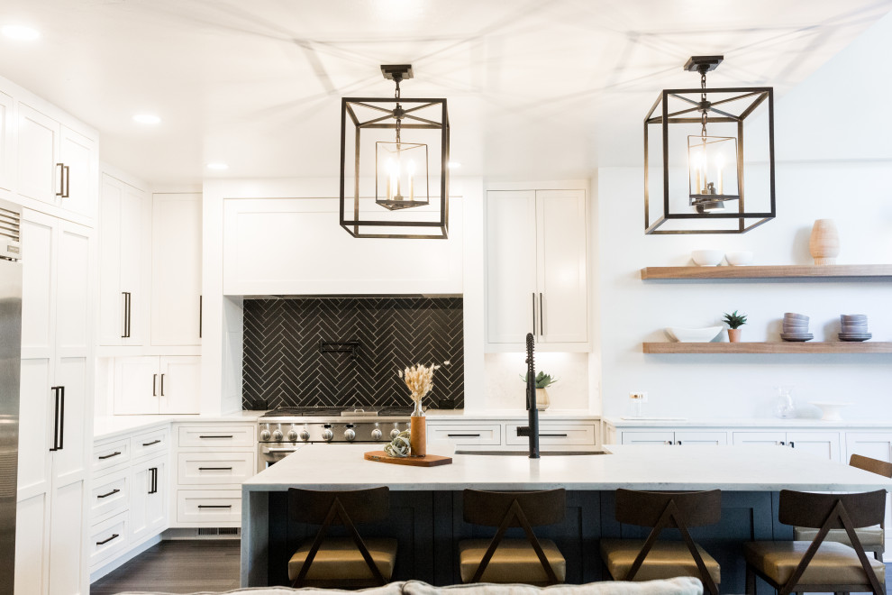 Inspiration for a large contemporary l-shaped laminate floor and black floor open concept kitchen remodel in Oklahoma City with a farmhouse sink, shaker cabinets, white cabinets, quartz countertops, black backsplash, ceramic backsplash, stainless steel appliances, an island and white countertops
