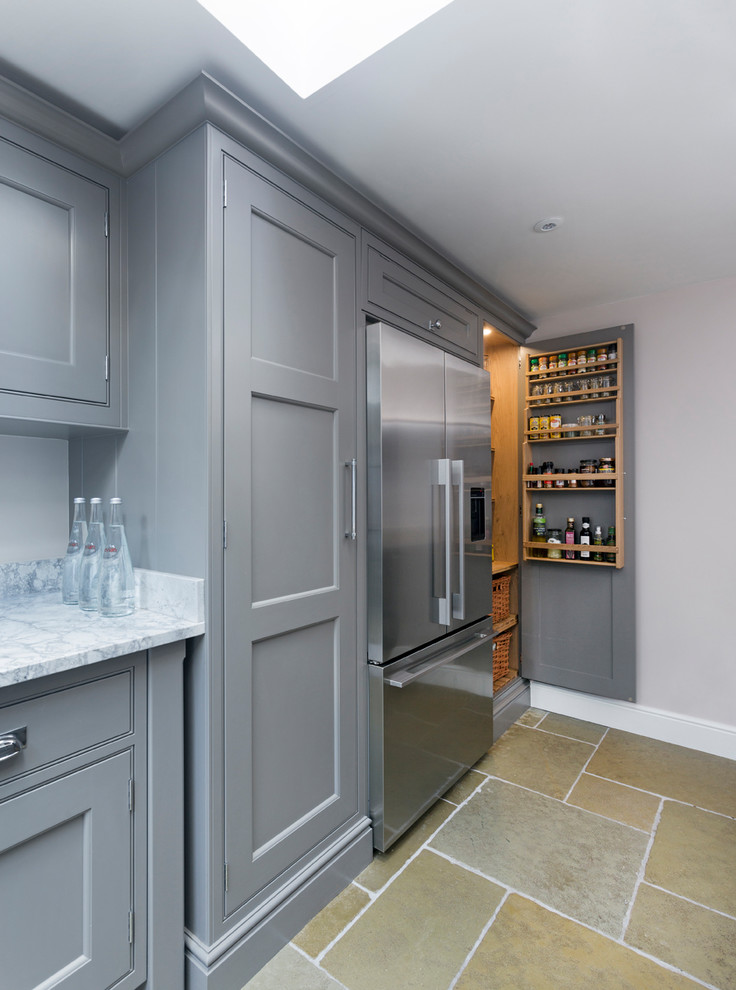 Design ideas for a small traditional galley kitchen/diner in Hampshire with a double-bowl sink, flat-panel cabinets, grey cabinets, marble worktops, mirror splashback, stainless steel appliances, limestone flooring, no island and beige floors.