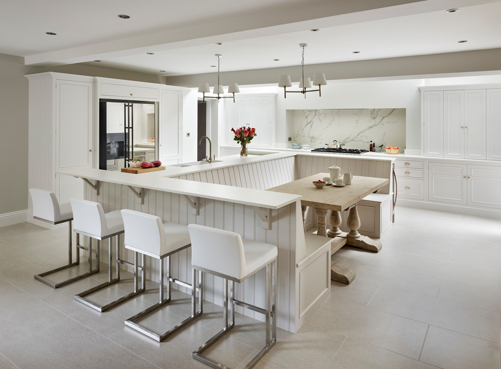 Exempel på ett stort klassiskt kök, med luckor med upphöjd panel, vita skåp, vitt stänkskydd, en halv köksö, grått golv, stänkskydd i marmor och rostfria vitvaror