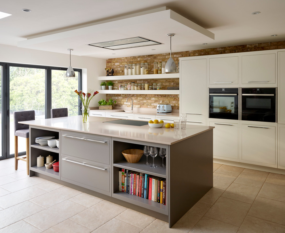 Example of a trendy kitchen design in London with an undermount sink, open cabinets, black appliances and an island