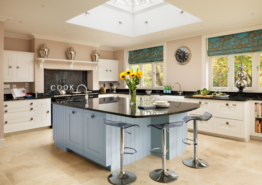 Design ideas for a traditional l-shaped kitchen in London with an island.