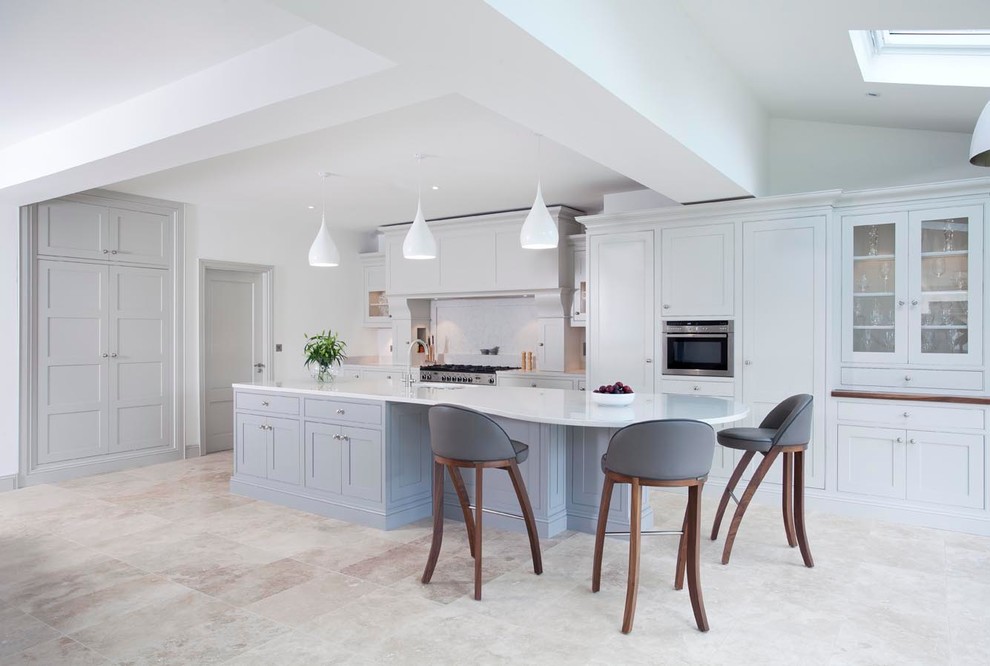 Inspiration for a contemporary l-shaped kitchen/diner in Dublin with a submerged sink, shaker cabinets, grey cabinets, engineered stone countertops, stone slab splashback, marble flooring and an island.