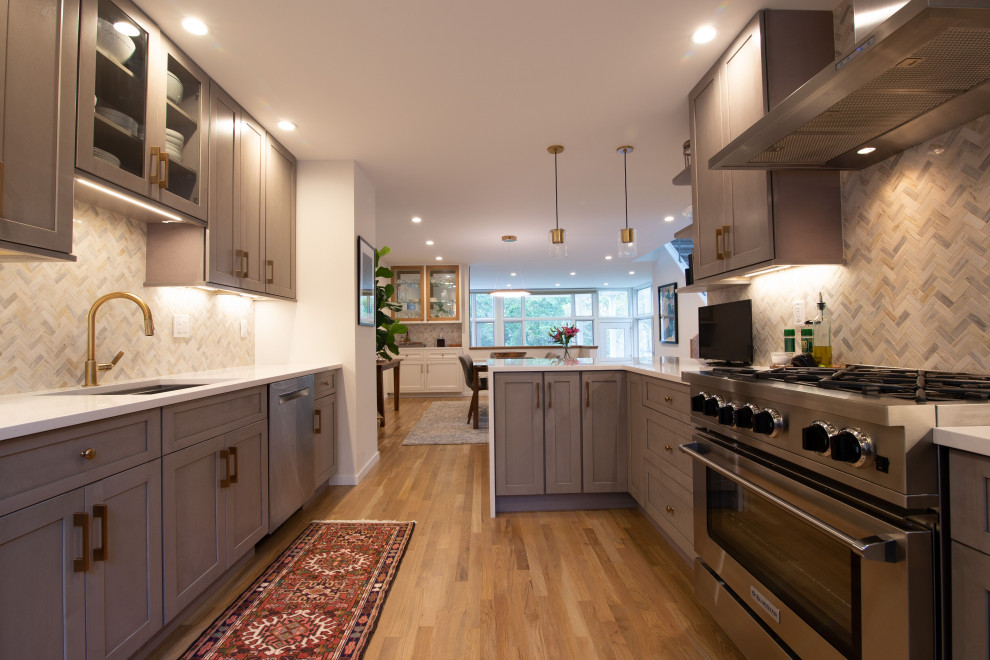 Small scandinavian galley enclosed kitchen in New York with a submerged sink, shaker cabinets, grey cabinets, engineered stone countertops, multi-coloured splashback, cement tile splashback, stainless steel appliances, light hardwood flooring, a breakfast bar, beige floors and white worktops.