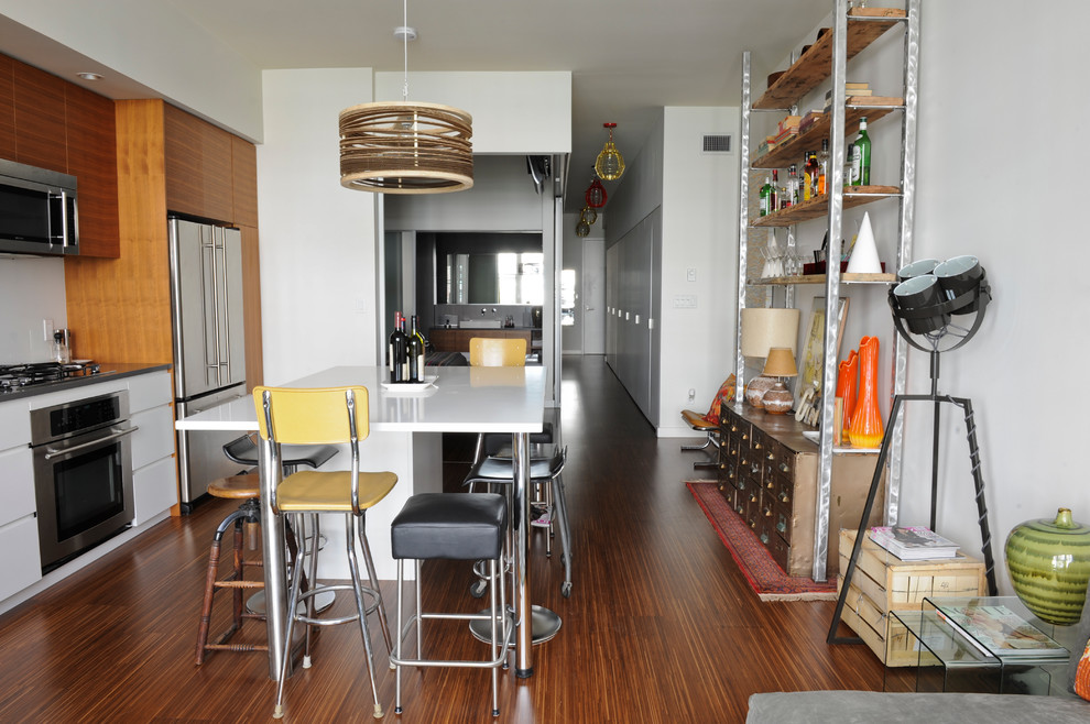 Urban single-wall eat-in kitchen photo in Vancouver with flat-panel cabinets, medium tone wood cabinets and stainless steel appliances
