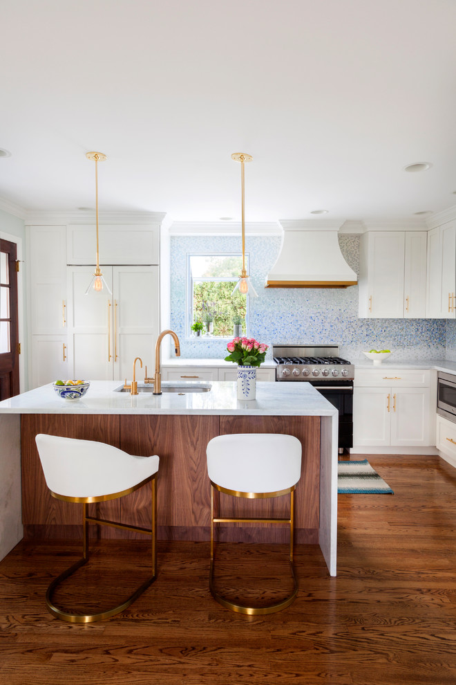 Example of a small transitional l-shaped dark wood floor kitchen design in Philadelphia with an undermount sink, white cabinets, quartzite countertops, blue backsplash, mosaic tile backsplash, an island, shaker cabinets and stainless steel appliances