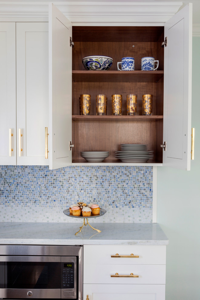 Design ideas for a small classic l-shaped kitchen/diner in Philadelphia with a submerged sink, white cabinets, quartz worktops, blue splashback, mosaic tiled splashback, medium hardwood flooring and an island.