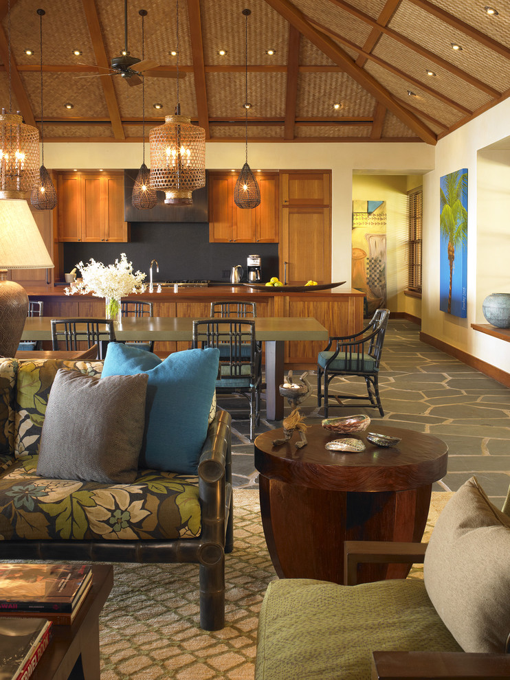 Inspiration for a tropical open concept kitchen remodel in Hawaii with recessed-panel cabinets, medium tone wood cabinets, black backsplash and stone slab backsplash