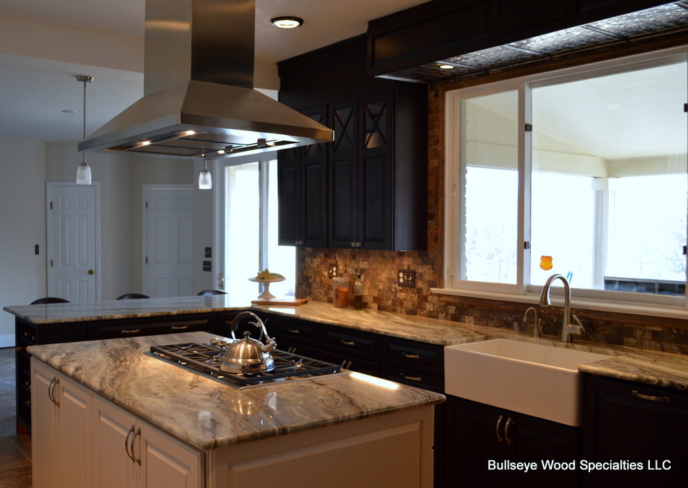 This is an example of a medium sized country l-shaped kitchen/diner in DC Metro with a belfast sink, raised-panel cabinets, dark wood cabinets, beige splashback, stainless steel appliances and an island.
