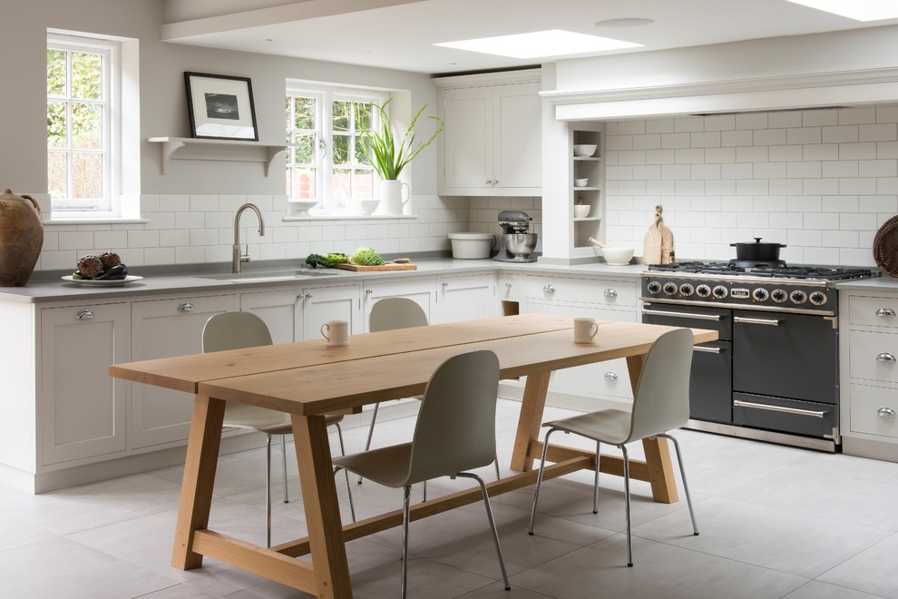Design ideas for a traditional l-shaped kitchen/diner in Sussex with a submerged sink, shaker cabinets, grey cabinets, white splashback, metro tiled splashback, coloured appliances, grey floors and grey worktops.