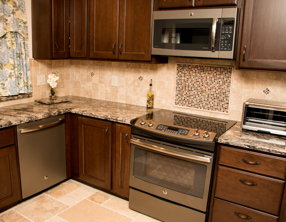 Example of a mid-sized transitional u-shaped travertine floor enclosed kitchen design in Other with an undermount sink, recessed-panel cabinets, dark wood cabinets, quartz countertops, beige backsplash, stone tile backsplash and colored appliances