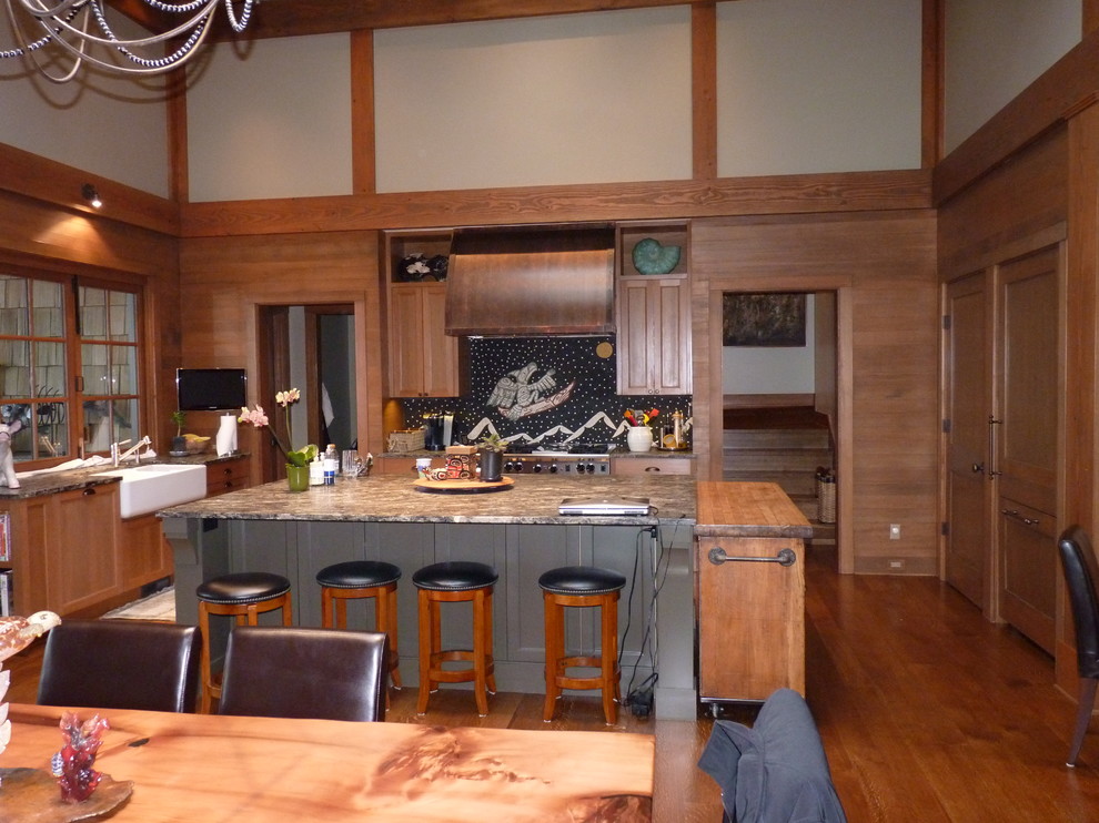 Arts and crafts u-shaped eat-in kitchen photo in Seattle with a farmhouse sink, shaker cabinets, medium tone wood cabinets, granite countertops and paneled appliances
