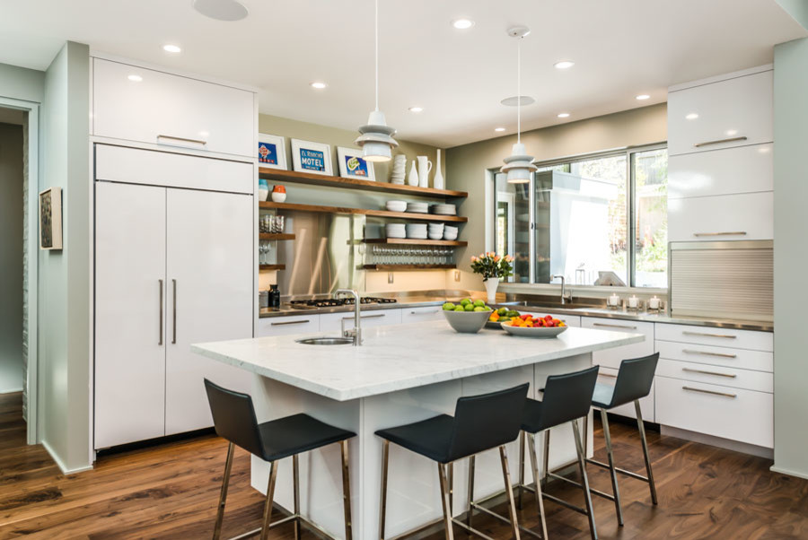 Example of a large minimalist l-shaped medium tone wood floor eat-in kitchen design in San Francisco with a single-bowl sink, flat-panel cabinets, white cabinets, marble countertops, metallic backsplash, an island and stainless steel appliances