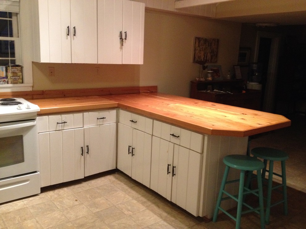Inspiration for a kitchen remodel in Miami with wood countertops