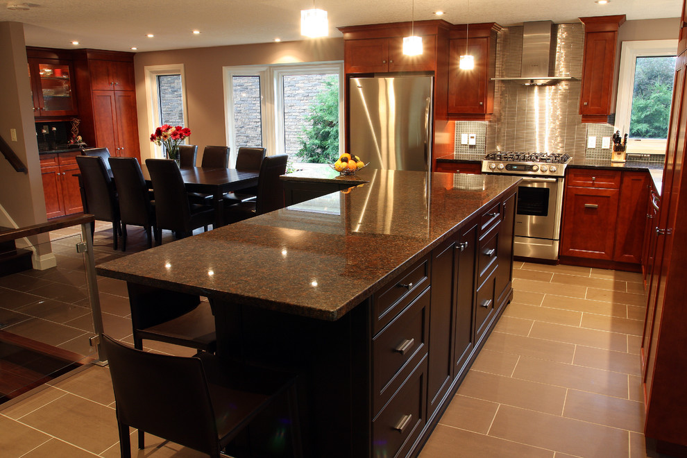 Example of a trendy l-shaped eat-in kitchen design in Toronto with stainless steel appliances, granite countertops, shaker cabinets, dark wood cabinets and gray backsplash