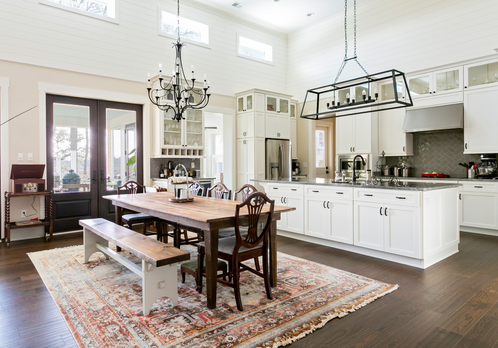 This is an example of a farmhouse kitchen/diner in Charleston with shaker cabinets, white cabinets, grey splashback, stainless steel appliances, dark hardwood flooring, an island and grey worktops.
