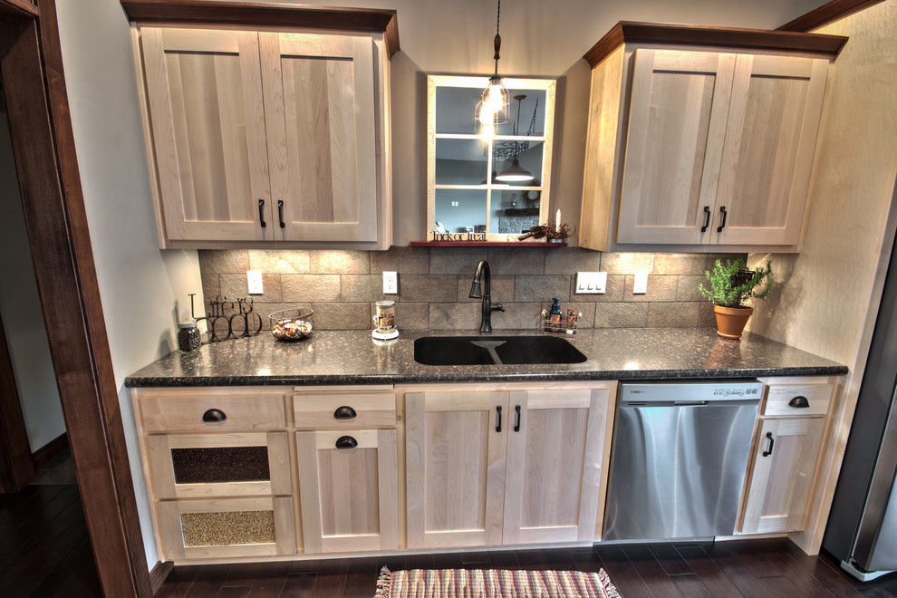 Example of a mid-sized classic single-wall dark wood floor eat-in kitchen design in Other with an undermount sink, shaker cabinets, light wood cabinets, laminate countertops, beige backsplash, stone tile backsplash, stainless steel appliances and no island