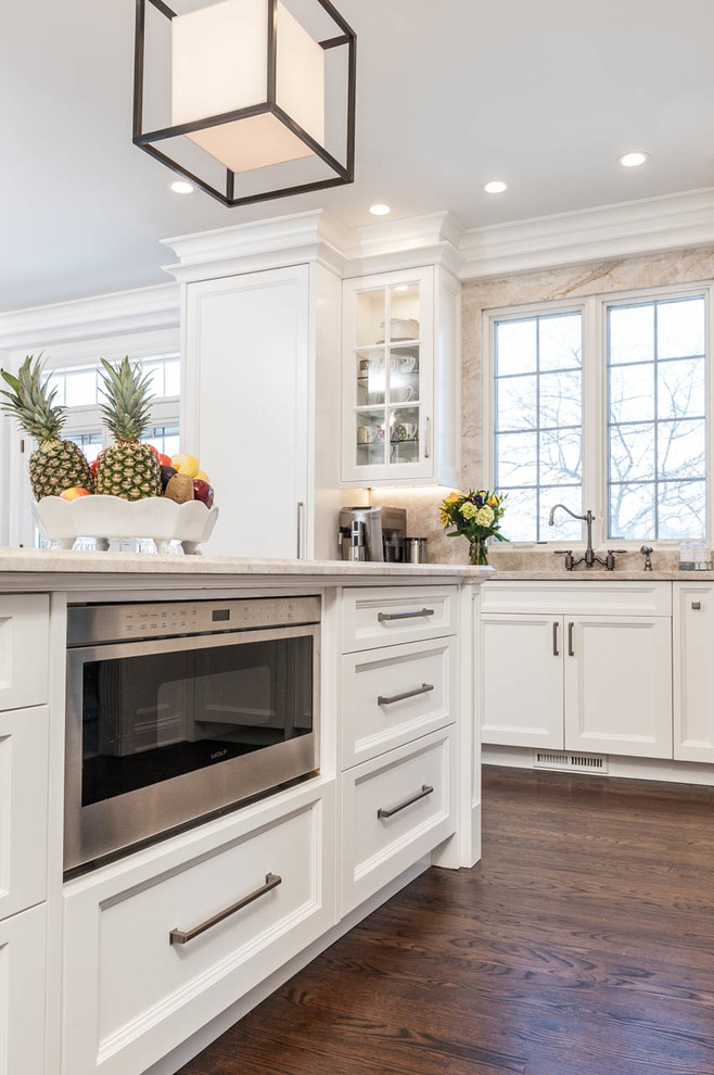 Example of a large transitional u-shaped medium tone wood floor eat-in kitchen design in Indianapolis with an undermount sink, white cabinets, onyx countertops, multicolored backsplash, stone slab backsplash, stainless steel appliances and an island