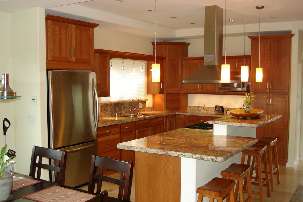 Inspiration for a medium sized classic l-shaped kitchen/diner in Hawaii with a double-bowl sink, shaker cabinets, medium wood cabinets, granite worktops, stainless steel appliances, ceramic flooring and an island.