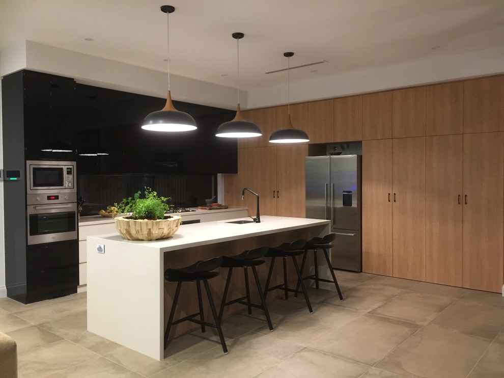 Example of a trendy kitchen design in Adelaide with a single-bowl sink, quartz countertops and stainless steel appliances