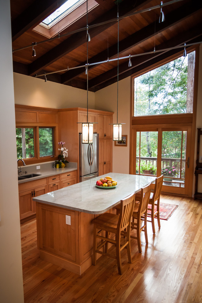 Enclosed kitchen - mid-sized craftsman l-shaped medium tone wood floor enclosed kitchen idea in San Francisco with a double-bowl sink, shaker cabinets, light wood cabinets, quartzite countertops, green backsplash, stone slab backsplash, stainless steel appliances and an island