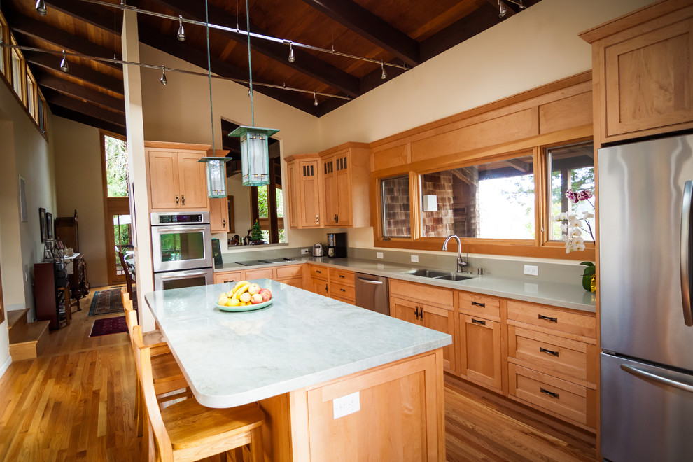 Photo of a medium sized classic l-shaped enclosed kitchen in San Francisco with a double-bowl sink, shaker cabinets, medium wood cabinets, quartz worktops, stainless steel appliances, medium hardwood flooring and an island.