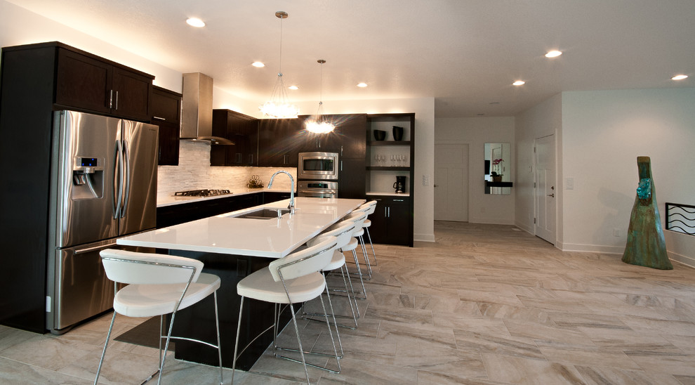 Inspiration for a modern l-shaped porcelain tile eat-in kitchen remodel in Other with an undermount sink, flat-panel cabinets, dark wood cabinets, quartz countertops, gray backsplash, stone tile backsplash, stainless steel appliances and an island