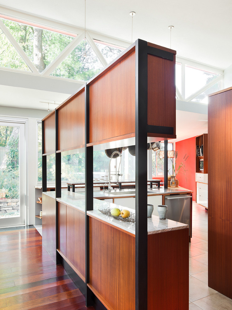 Example of a mid-sized 1960s galley ceramic tile open concept kitchen design in Philadelphia with a drop-in sink, flat-panel cabinets, white cabinets, wood countertops, beige backsplash, stone tile backsplash, stainless steel appliances and an island