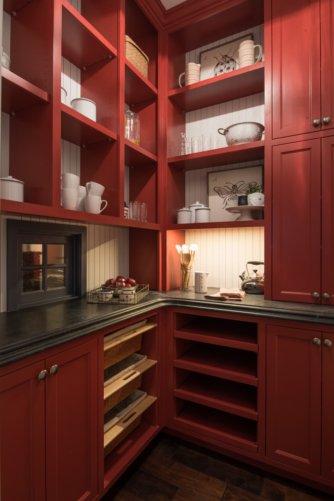 Inspiration for a medium sized traditional l-shaped kitchen pantry in Minneapolis with a belfast sink, recessed-panel cabinets, red cabinets, stainless steel worktops, grey splashback, stone slab splashback, stainless steel appliances, dark hardwood flooring, multiple islands and brown floors.
