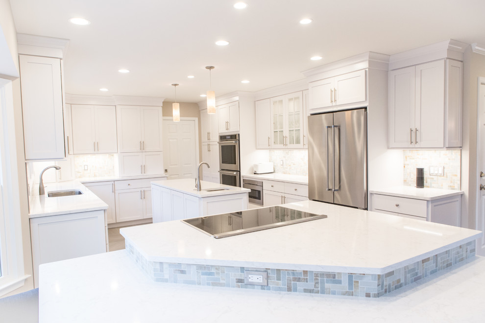 Inspiration for a large transitional u-shaped porcelain tile eat-in kitchen remodel in DC Metro with an undermount sink, shaker cabinets, white cabinets, quartz countertops, multicolored backsplash, stone tile backsplash, stainless steel appliances and two islands