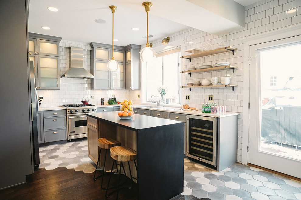 Mid-sized minimalist l-shaped cement tile floor and black floor open concept kitchen photo in Los Angeles with a single-bowl sink, glass-front cabinets, gray cabinets, marble countertops, white backsplash, ceramic backsplash, stainless steel appliances and an island