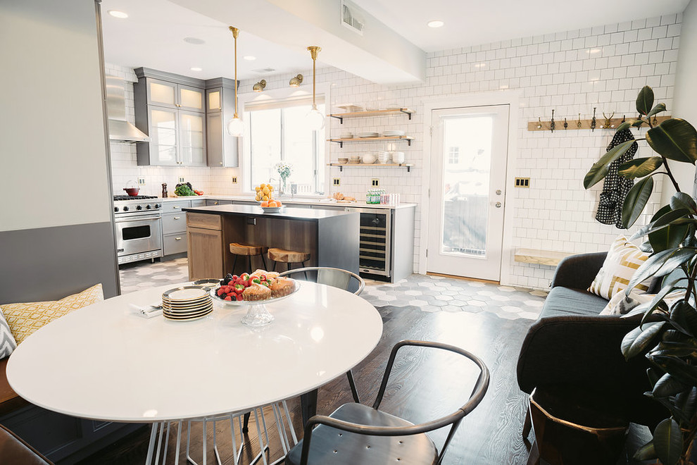 Open concept kitchen - mid-sized modern l-shaped cement tile floor and black floor open concept kitchen idea in Los Angeles with a single-bowl sink, glass-front cabinets, gray cabinets, marble countertops, white backsplash, ceramic backsplash, stainless steel appliances and an island