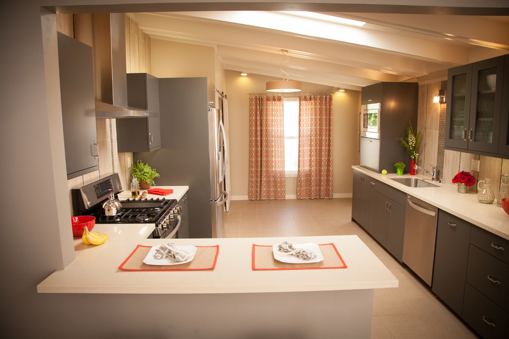 Example of a transitional galley eat-in kitchen design in Los Angeles with an undermount sink, flat-panel cabinets, gray cabinets, quartzite countertops, beige backsplash, glass tile backsplash and stainless steel appliances