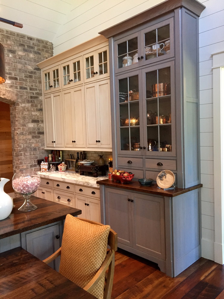 Example of a large country u-shaped medium tone wood floor eat-in kitchen design in Atlanta with white cabinets, white backsplash, stainless steel appliances and an island