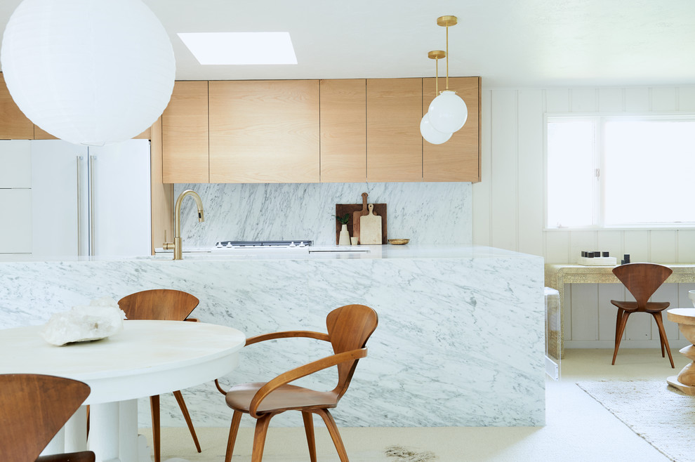 Photo of a medium sized u-shaped kitchen/diner in Other with a submerged sink, raised-panel cabinets, marble worktops, white splashback, marble splashback, white appliances, a breakfast bar and light wood cabinets.