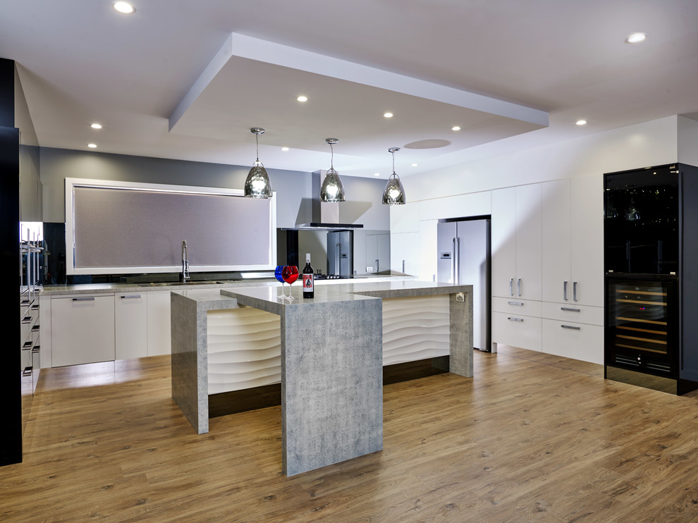 Large urban u-shaped laminate floor and brown floor eat-in kitchen photo in Other with a drop-in sink, flat-panel cabinets, white cabinets, quartz countertops, gray backsplash, mirror backsplash, black appliances, an island and gray countertops