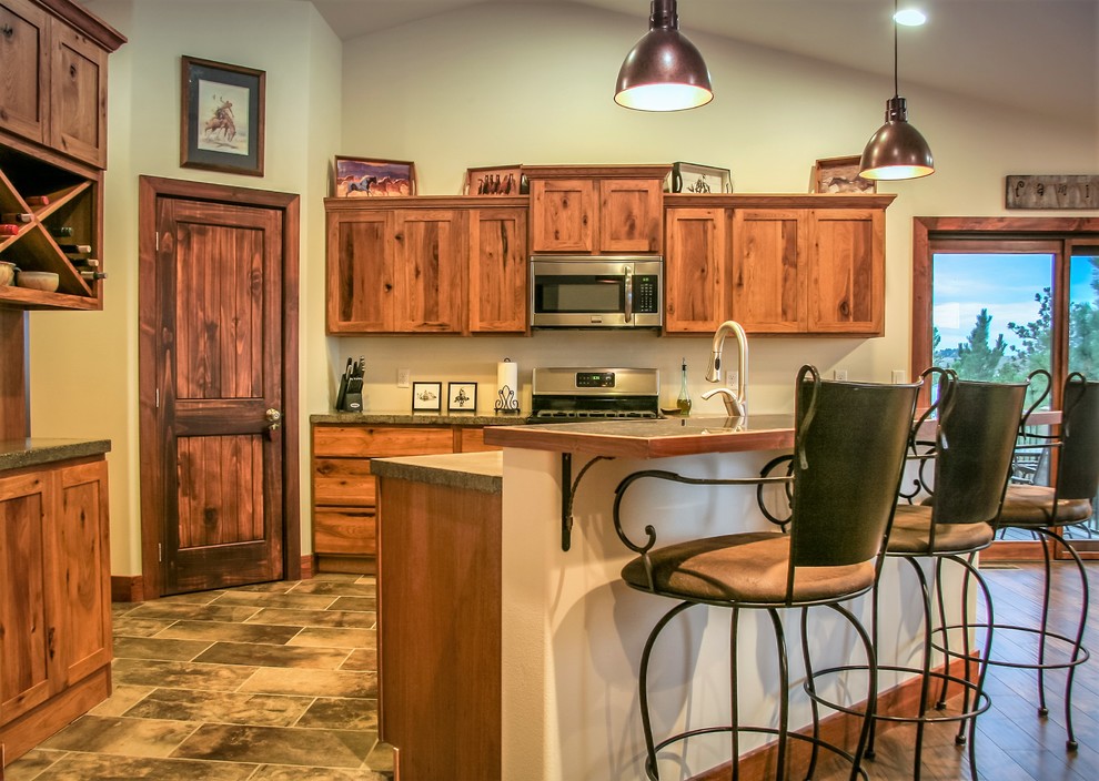 Offene, Mittelgroße Rustikale Küche in L-Form mit hellbraunen Holzschränken, Betonarbeitsplatte, Küchengeräten aus Edelstahl und Kücheninsel in Sonstige