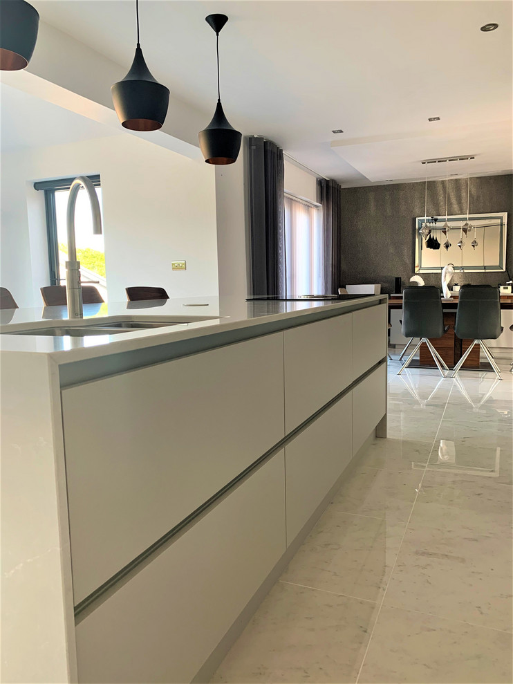 Inspiration for a large contemporary l-shaped open plan kitchen in Other with a built-in sink, flat-panel cabinets, dark wood cabinets, engineered stone countertops, black appliances, porcelain flooring and an island.