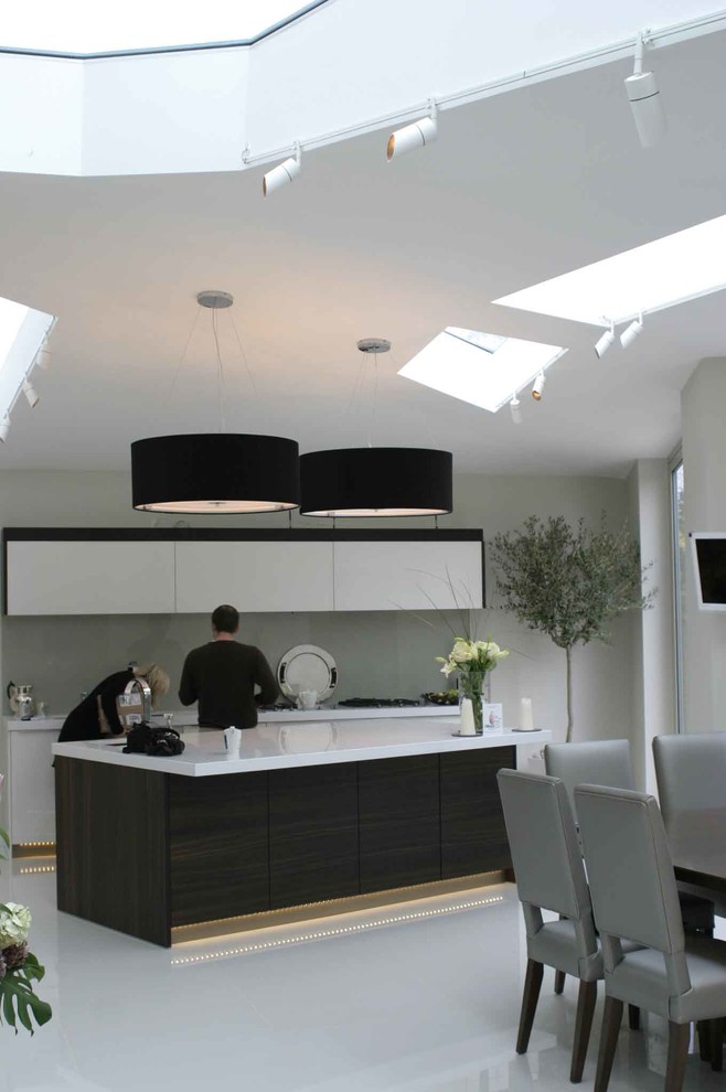 Design ideas for a contemporary enclosed kitchen in London with white cabinets.