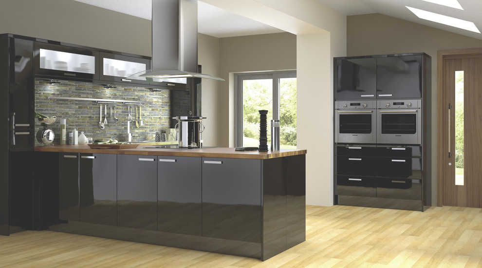 Inspiration for a contemporary kitchen in Hampshire with flat-panel cabinets, black cabinets and wood worktops.